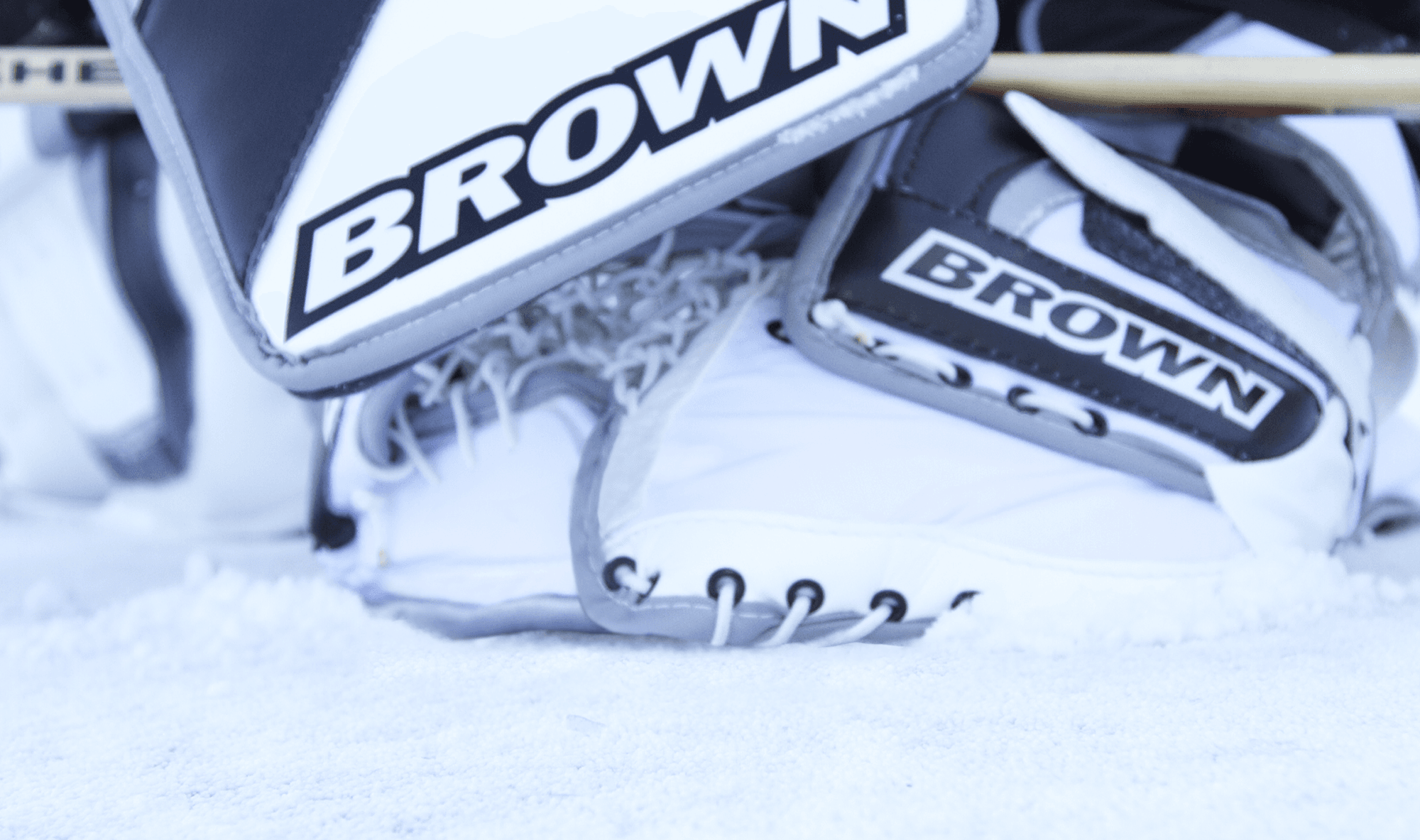Catch glove and blocker covering the puck.