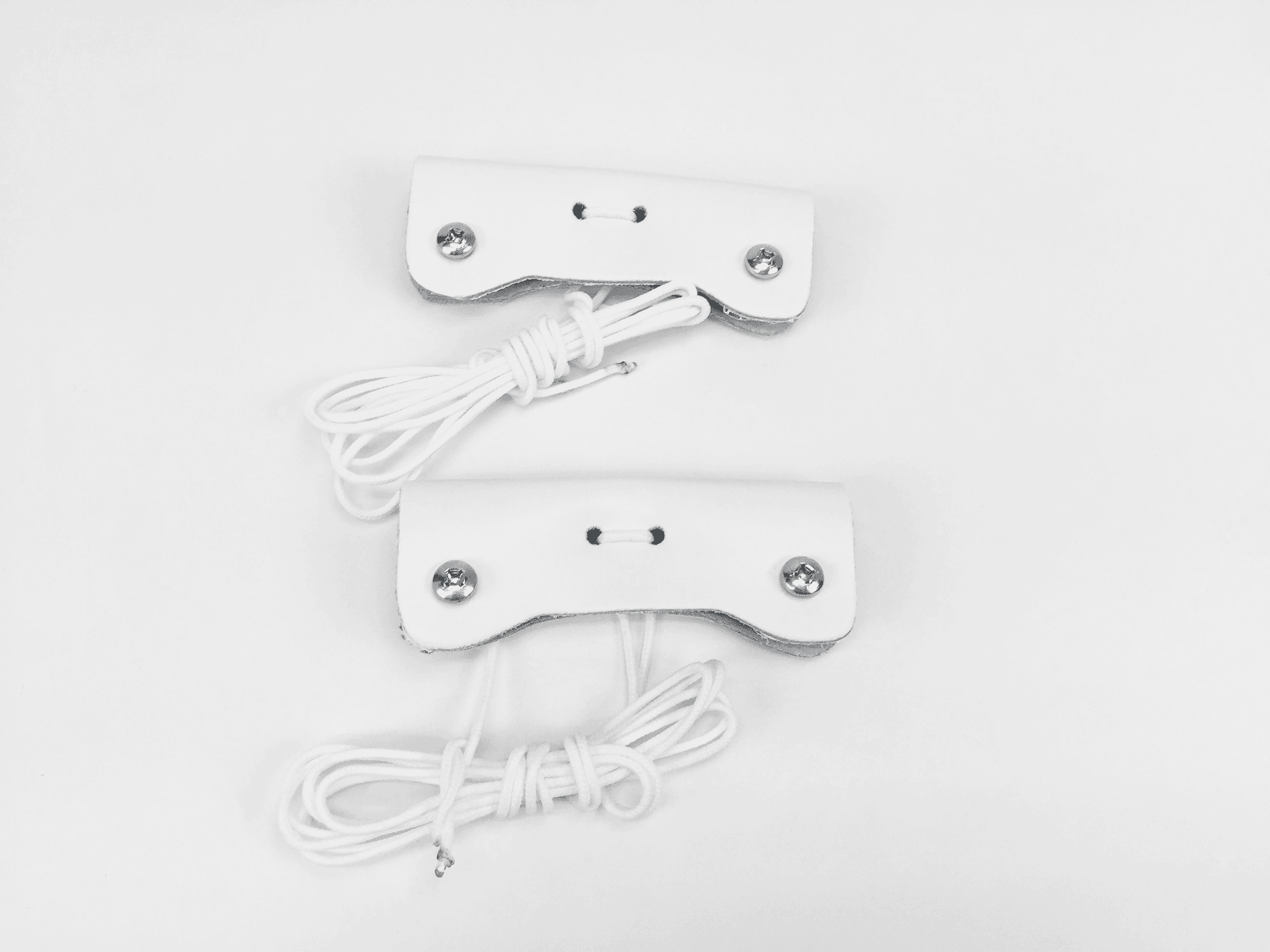 Two white classic toe assemblies