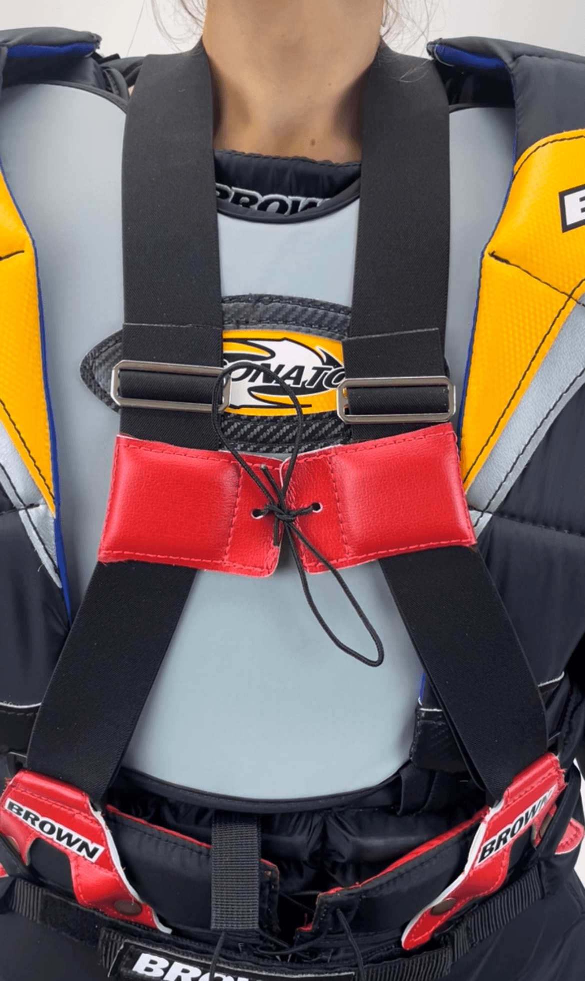 Suspenders over chest protector