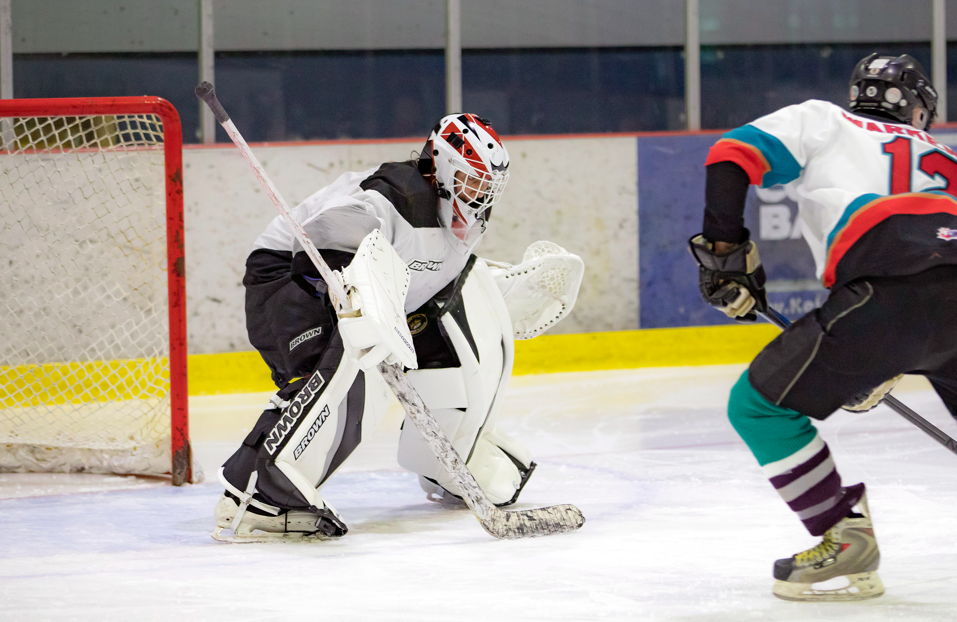 A goalie facing a player in close range shooting