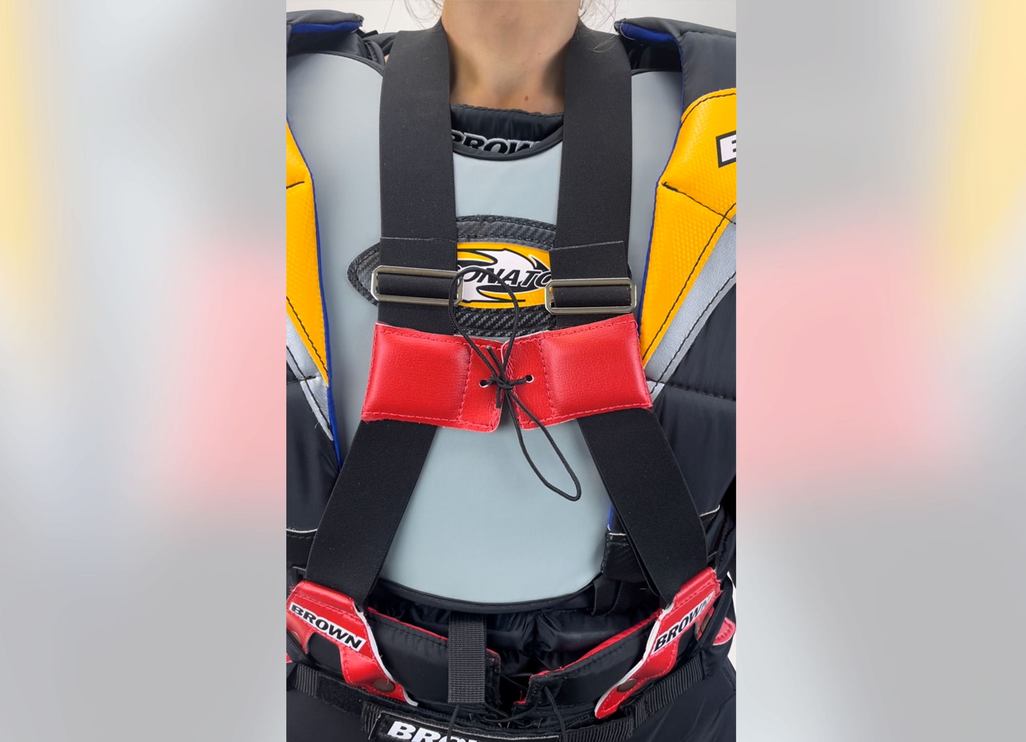 Suspenders over chest protector